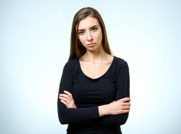 istock Beautiful young confident woman with serious expression isolated on gray 688107362