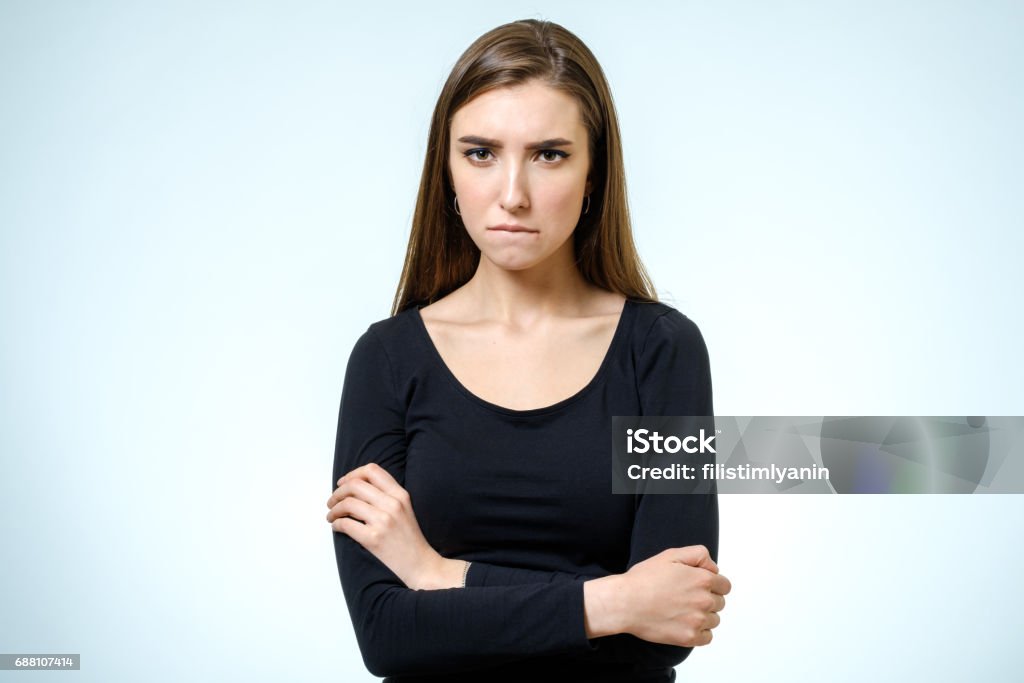 Young upset woman. Isolated on white background. Studio shot Anger Stock Photo