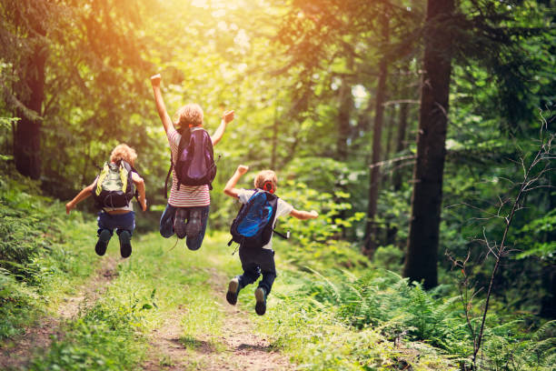 istock Happy little hikers jumping with joy 688110568
