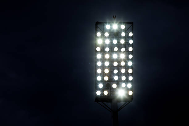 Stadium lights against dark night sky background