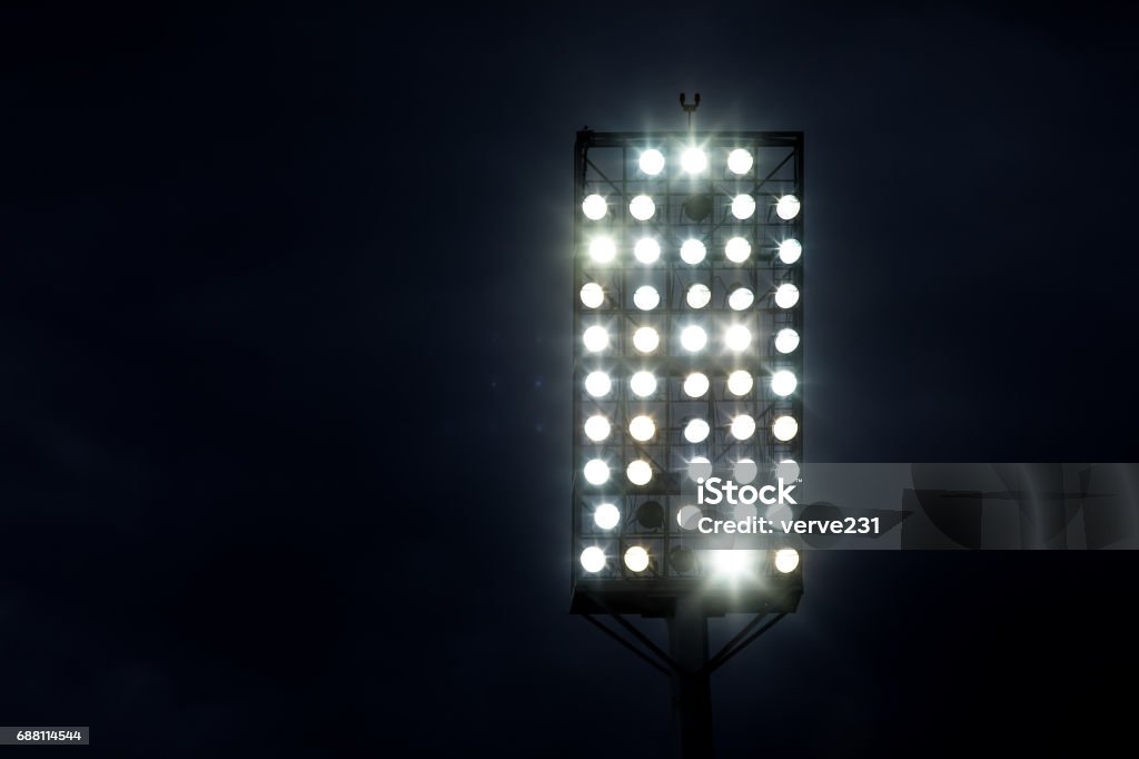 Stadium lights against dark night sky background Floodlight Stock Photo