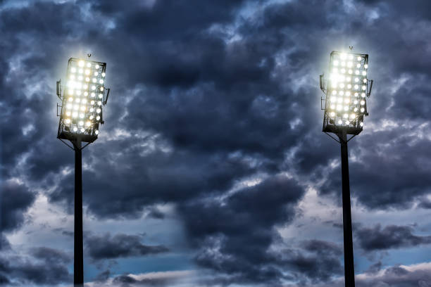 istock Stadium lights against dark night sky background 688116880