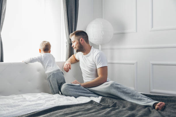 istock Father with his son looking out of the window 688120002