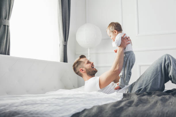 istock Happy father with his son playing at home on the bed 688120502