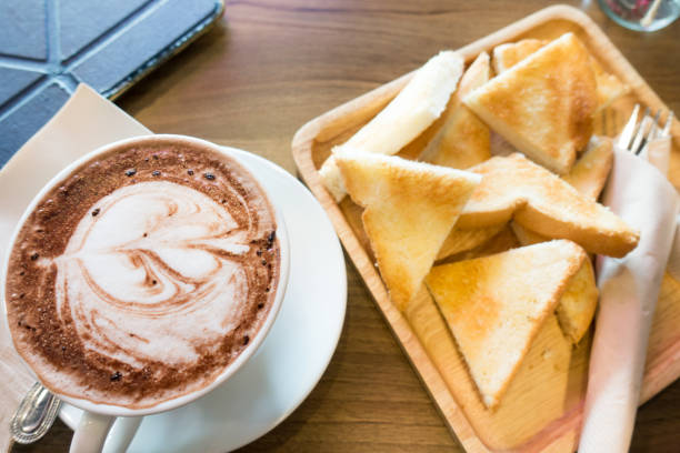 istock Hot chocolate in white cup on wooden table 688120882