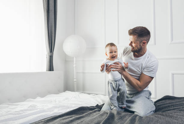 istock Happy father with his son playing at home on the bed 688121378