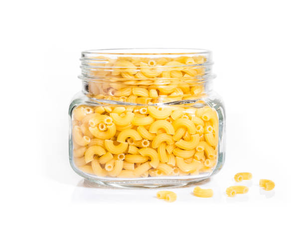 istock raw macaroni pasta in clear glass jar on isolated white background 688124510