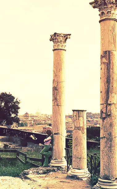 Vintage image from the seventies featuring a woman at the Roman Forum in Rome, Italy.