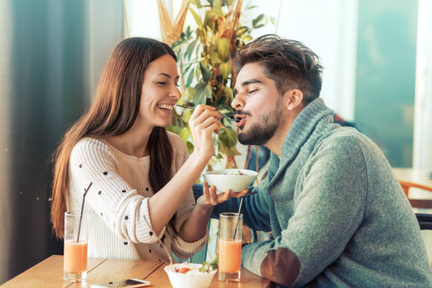 istock Happy young couple having breakfast in cafe 688127996