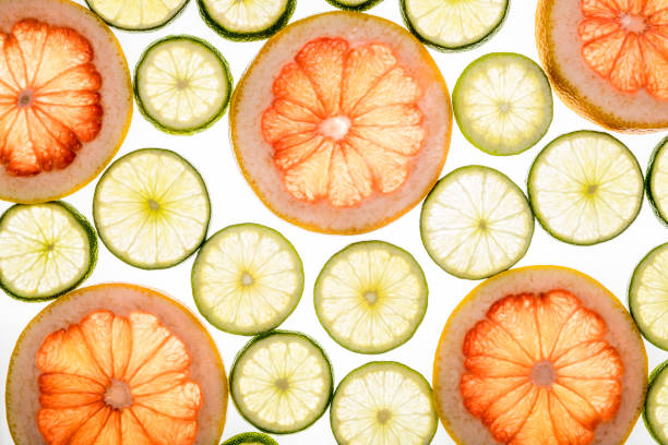 istock Bright lime and grapefruit slices. Juicy transparent fruit on white 688129174