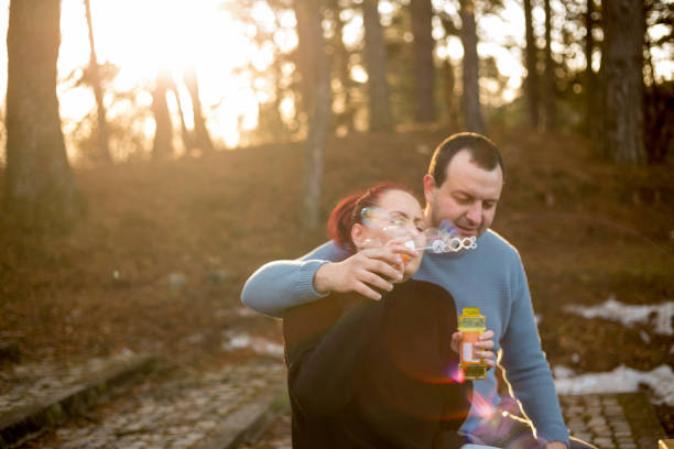 istock couple in love walking in the woods 688141124