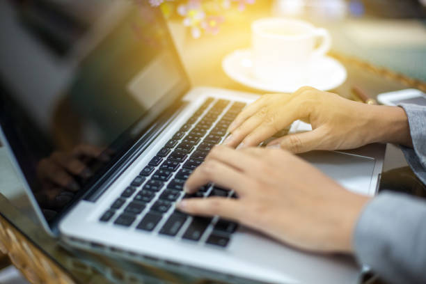 istock woman's hands using laptop with blank screen on table in offie 688141560