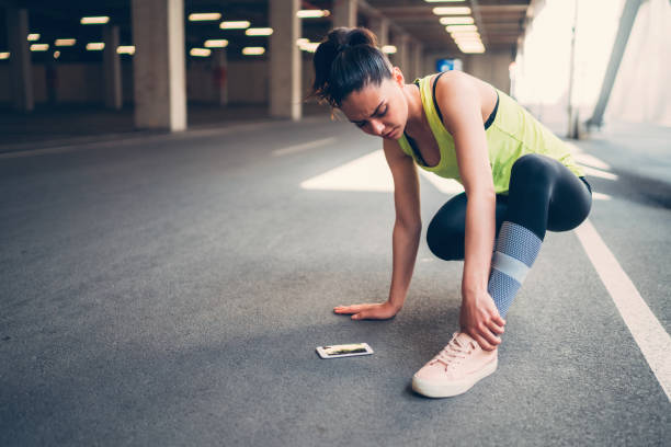 Sportswoman with injured ankle Young woman with aching leg muscle and joint aches stock pictures, royalty-free photos & images