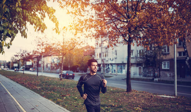 istock Young man jogging in the city 688144610