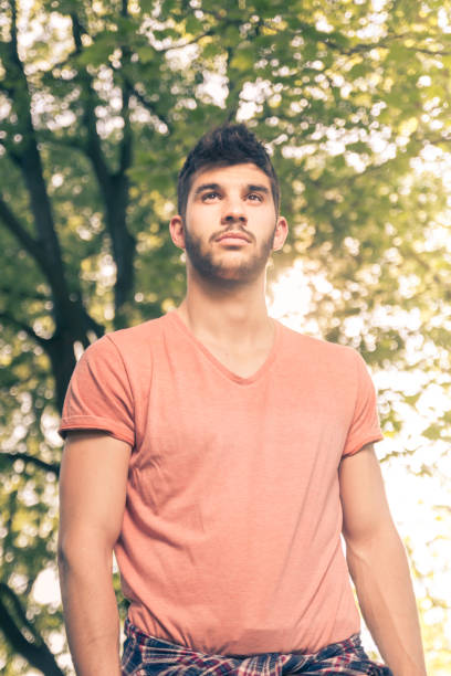 istock one young man, upper body portrait, low angle view 688151478