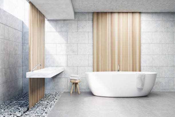 istock Gray brick bathroom, white tub, front 688154624