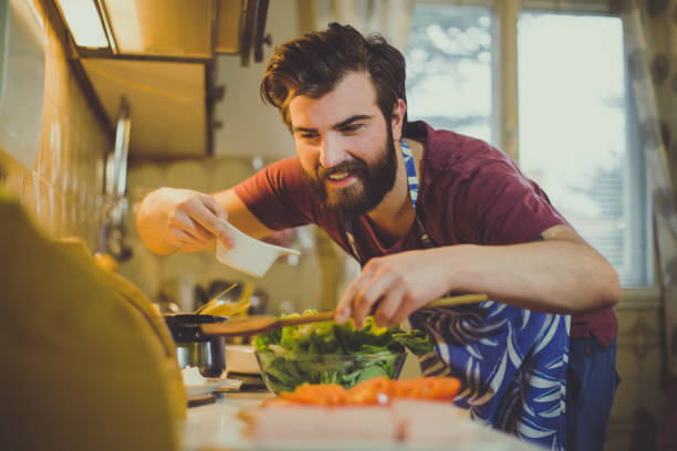istock Handsome bearded man preparing food in the kitchen 688157178