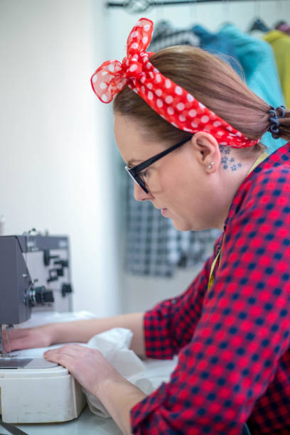 istock Seamstress woman preparing material 688164302