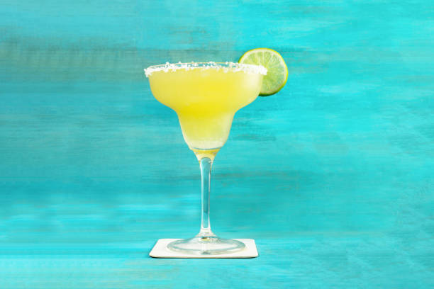 istock Lemon Margarita cocktail on vibrant turquoise with copyspace 688169626