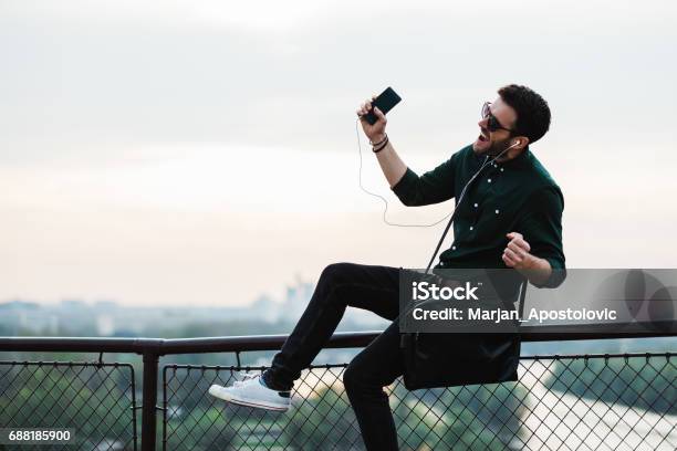 Young Man Listening To The Music Stock Photo - Download Image Now - Dancing, Street, Mobile Phone