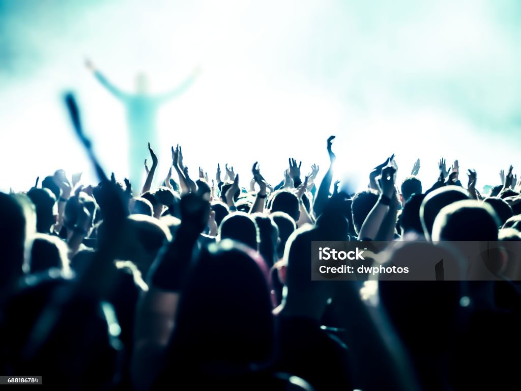 cheering crowd at a rock concert Crowd of People Stock Photo
