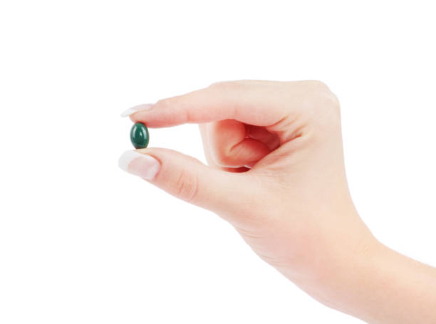 istock close up round white pill in hand 688192396