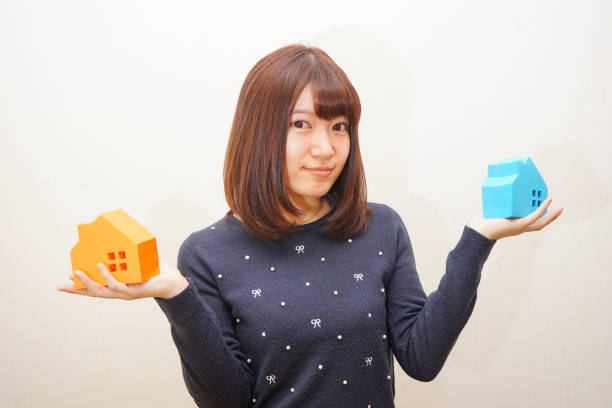 istock Woman with a model of a House 688192568