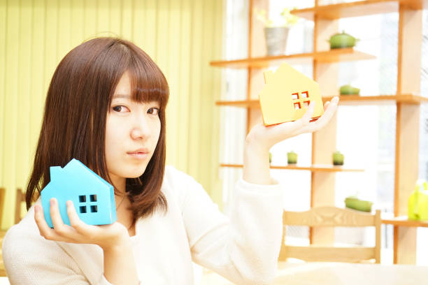 istock Woman with a model of a House 688199624