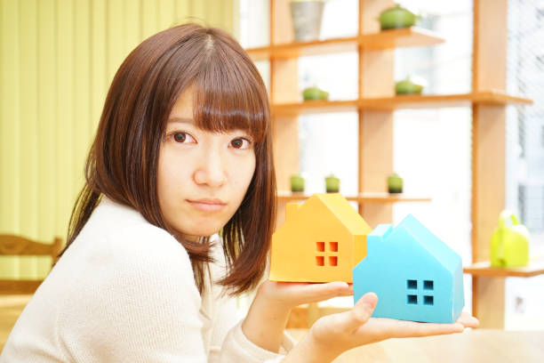 istock Woman with a model of a House 688199640