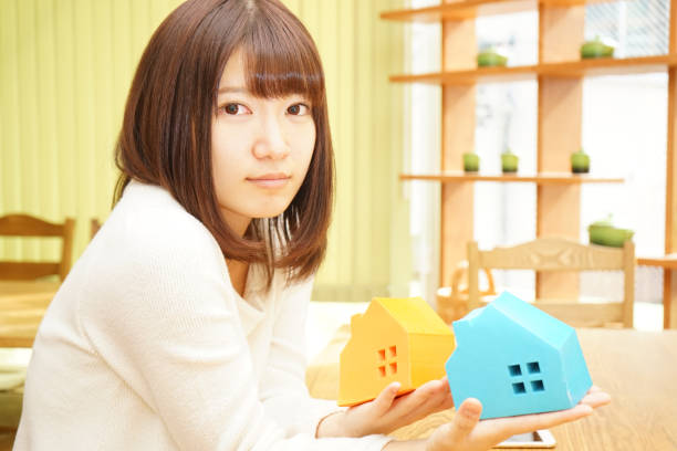 istock Woman with a model of a House 688199644
