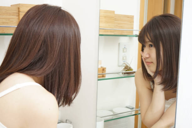 istock Women in front of the mirror 688205954