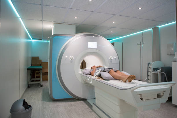 istock Female patient lying while she waits for her MRI scan 688206268