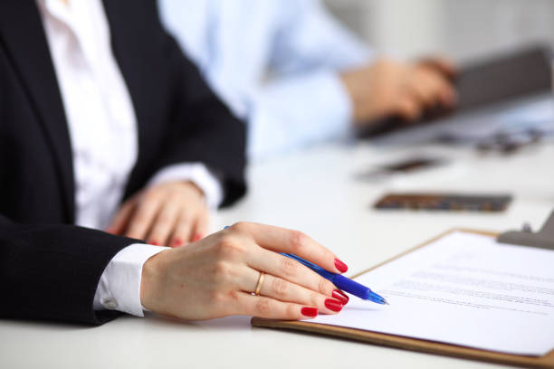 istock Young businesswoman sitting on the desk with folder, contract 688225836