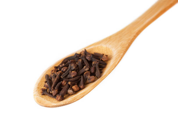istock Cloves in wooden spoon isolated on white 688230776