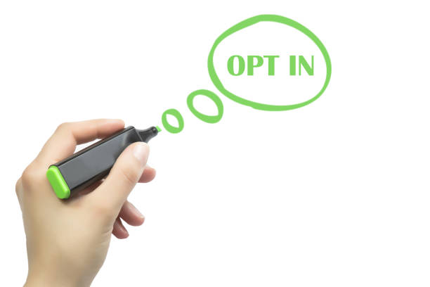 istock hand writing opt in. talking balloon with marker on white paper 688234578