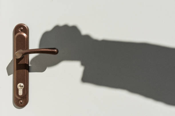 istock Shadow of hands on the door handle 688239060