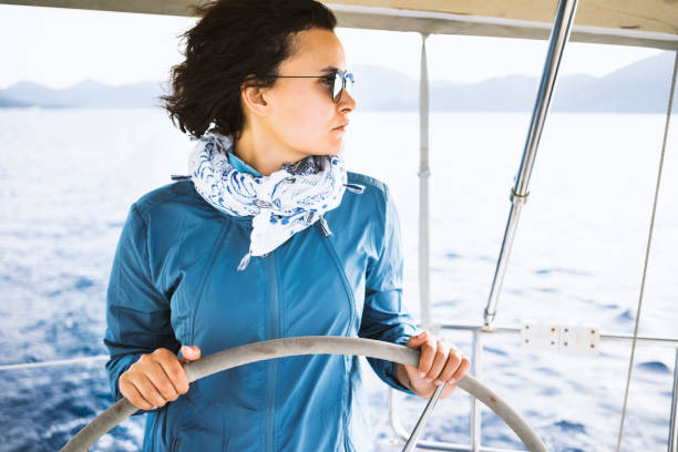 istock Woman using the boat's wheel, sailing 688239520
