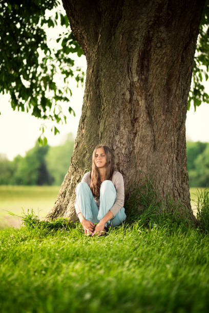 istock Beautiful women relaxing under a chestnut-tree 688239634