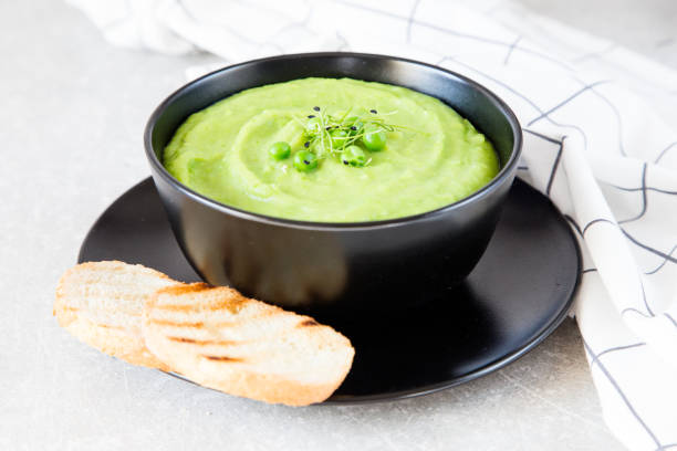 istock Homemade puree soup with green peas and micro greens. selective focus 688246508