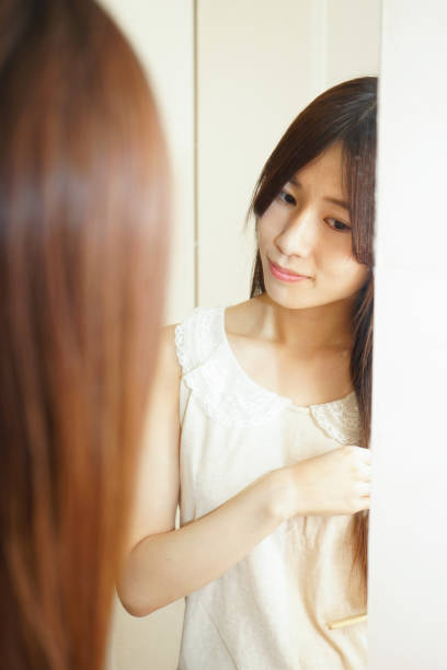 istock Women in front of the mirror 688252594