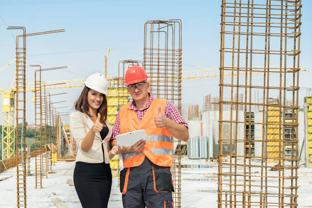 istock Woman engineer and male worker at construction site 688252834
