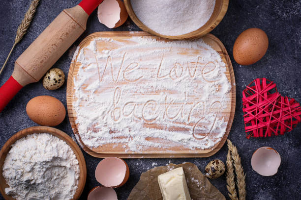 istock Egg, flour, sugar, butter and board with text We love backing 688256482