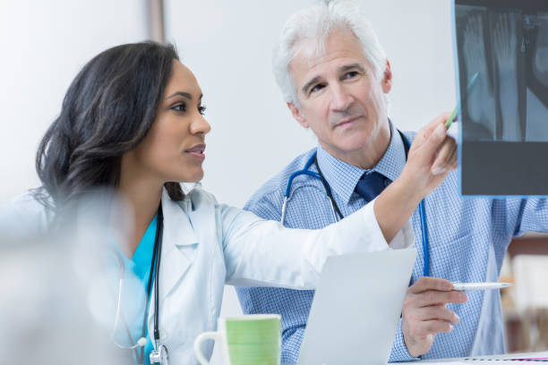 istock Two orthopedic doctors discuss patient's x-ray 688278746