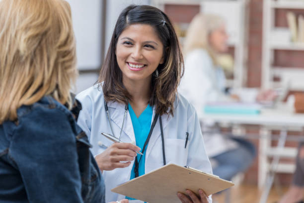 istock Asian physician consults with female patient 688278784