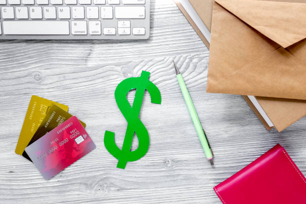 istock student's desk with dollar sign for fee-paying education set gray background top view mock up 688287372