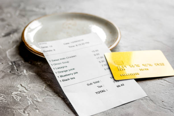 istock restaurant bill, card and plate on stone table background 688288204