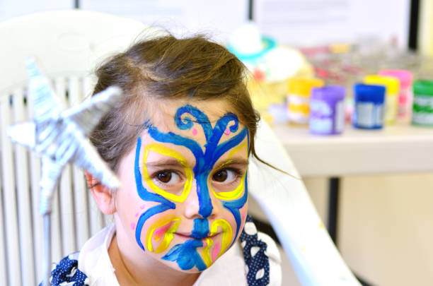 Portrait of a surprised child with a painted face on the holiday