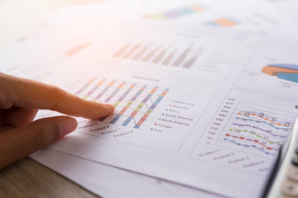 istock close up busninessman working with graph data at office,Finance managers task,Concept business and finance 688300768