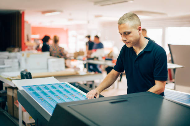 istock Young man working in printing factory 688301136