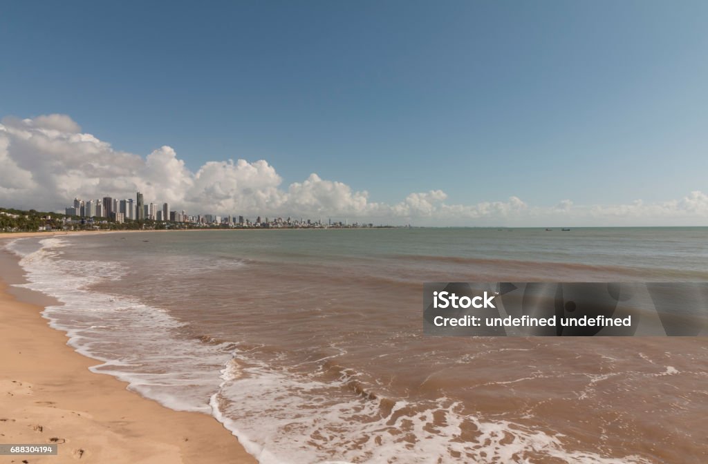 Cabo Branco beach in Joao Pessoa (PB), Brazil Cabo Branco beach is a place to be visited in Joao Pessoa (PB). The street behind is closed in morning hours for training and at night time it is a street where locals have walk and meet friends. Beach Stock Photo